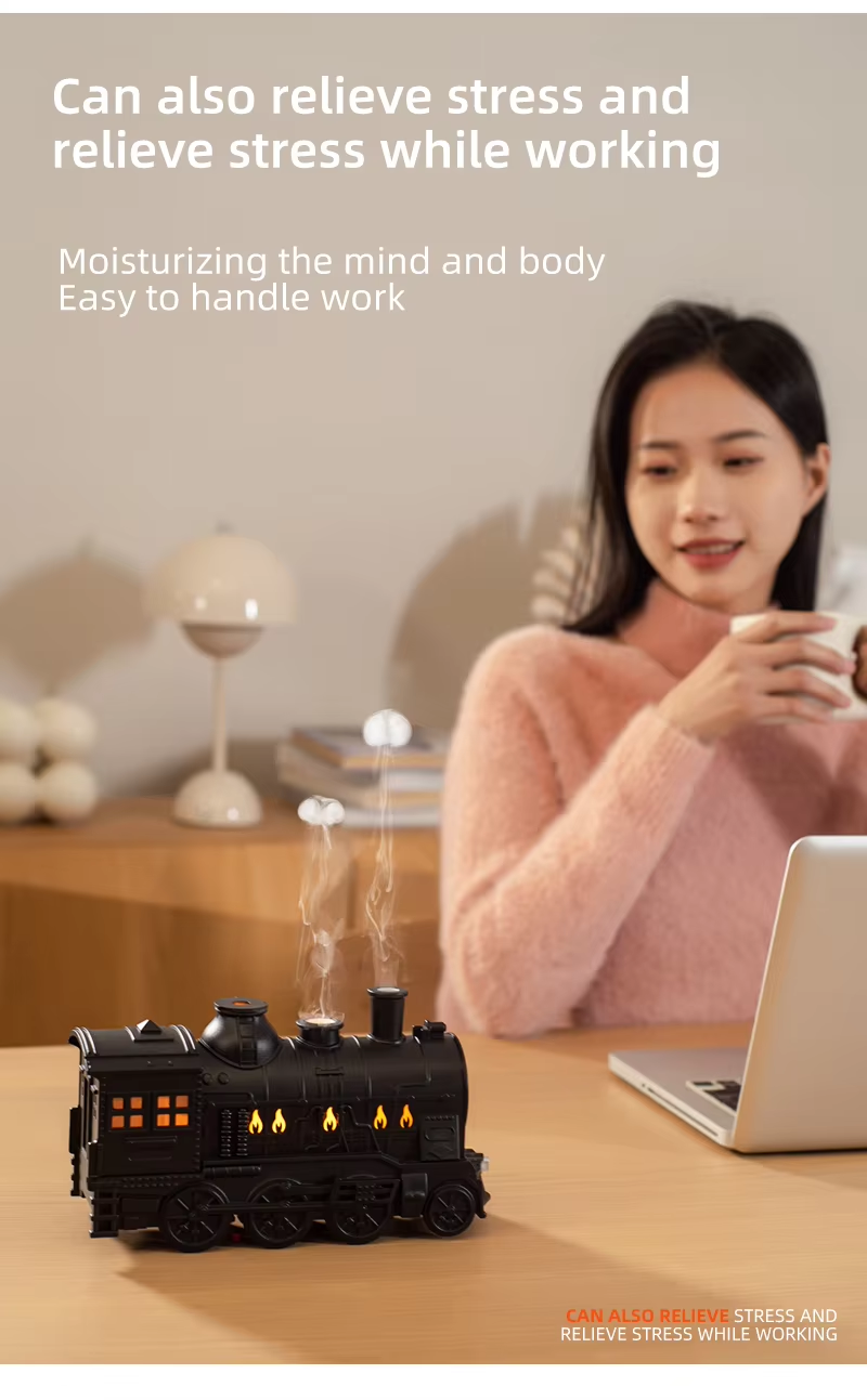 Black train aroma diffuser beside a person at a desk